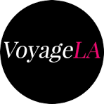 Black circular logo with the words 'Voyage LA' in white and pink text