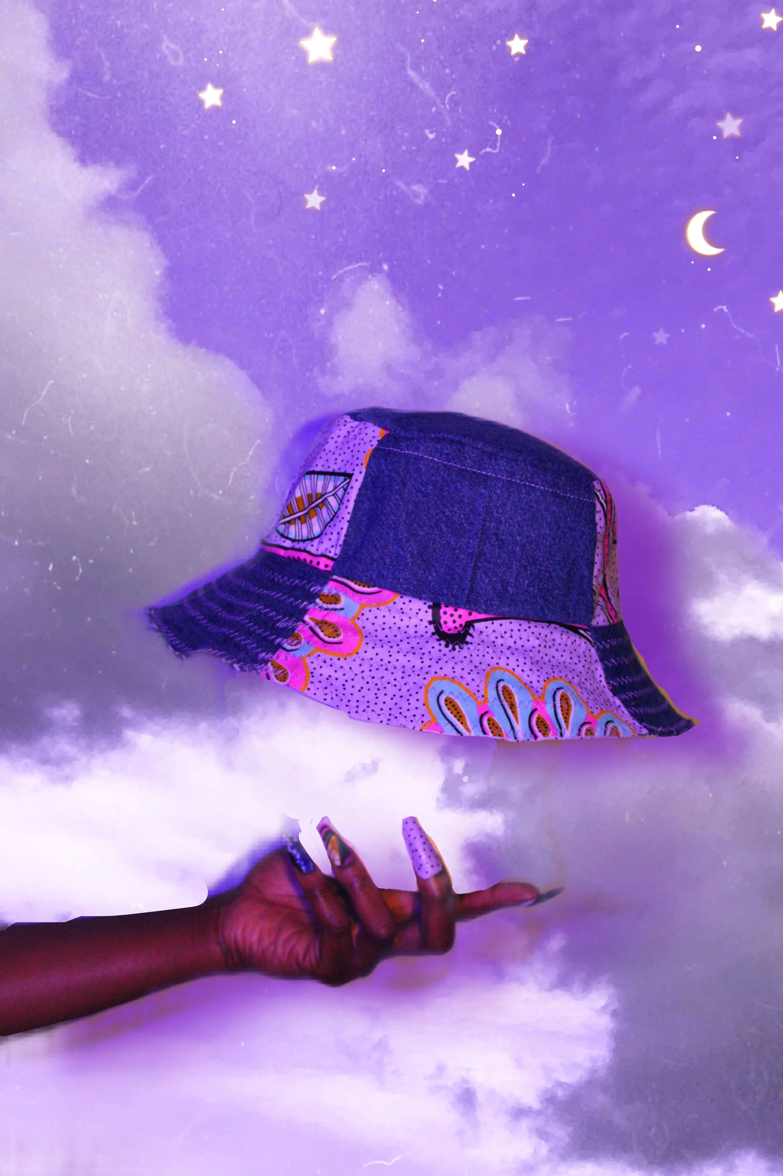 A hand with decorated nails and dark skin holding a patchwork bucket hat against a purple sky with clouds, stars, and a crescent moon projection.