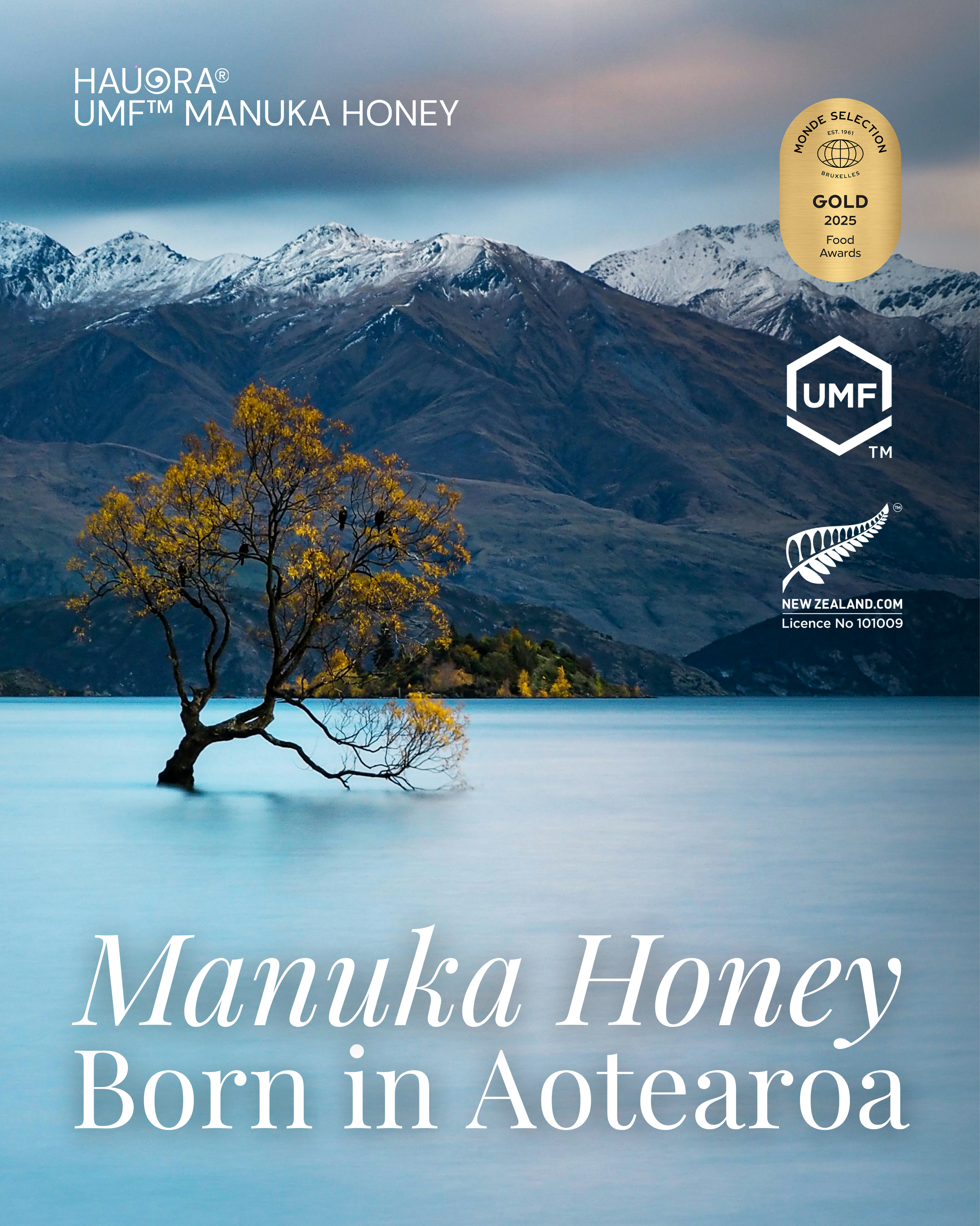 A scenic landscape featuring snow-capped mountains, a peaceful lake, and a tree with yellow leaves in the foreground. Text on the image reads 'Manuka Honey Born in Aotearoa' and a gold badge indicates it won a 2025 food award at Monde Selection.