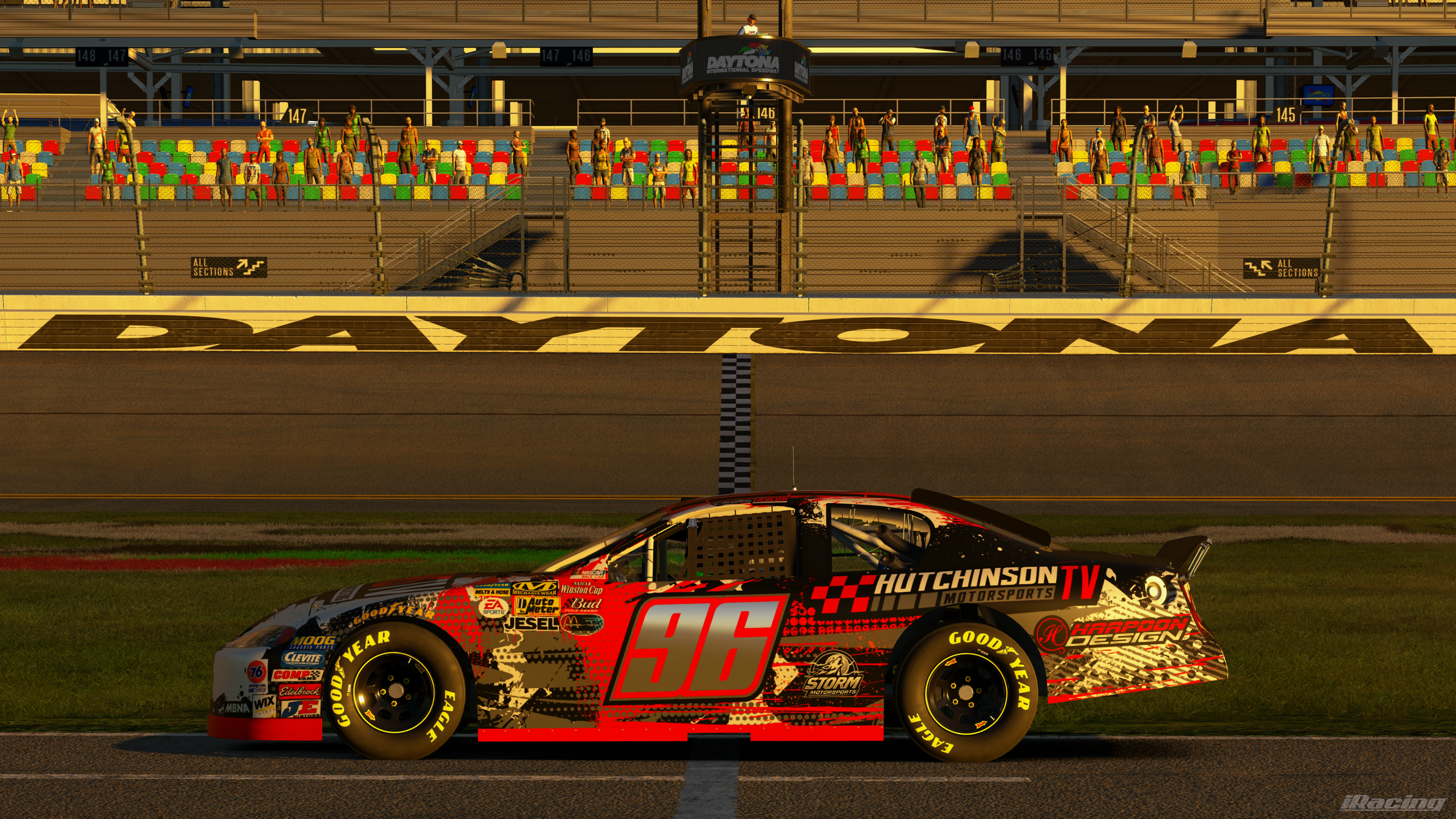 Race car crossing the finish line at Daytona International Speedway during sunset, with spectators in the stands