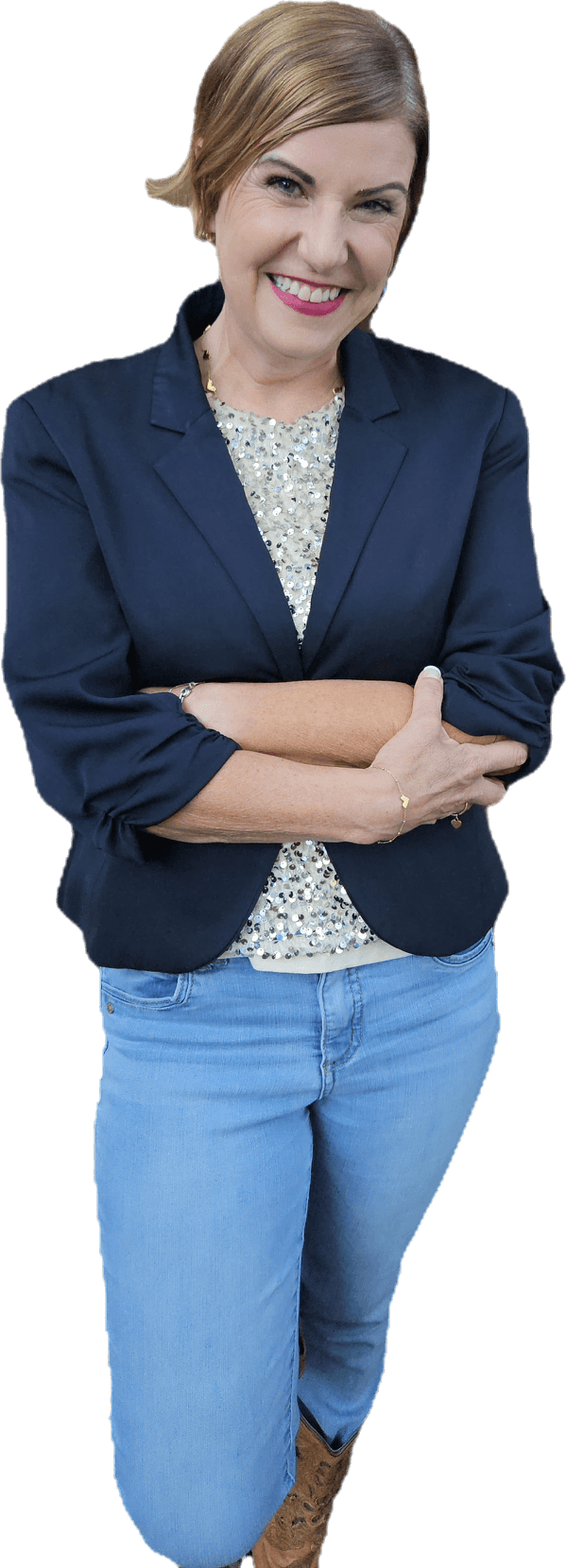 Rachel Muir, a vibrant nonprofit fundraising consultant, smiles warmly in a navy blazer over a sequin top, paired with light jeans, exuding fun and approachable energy for fundraising success.