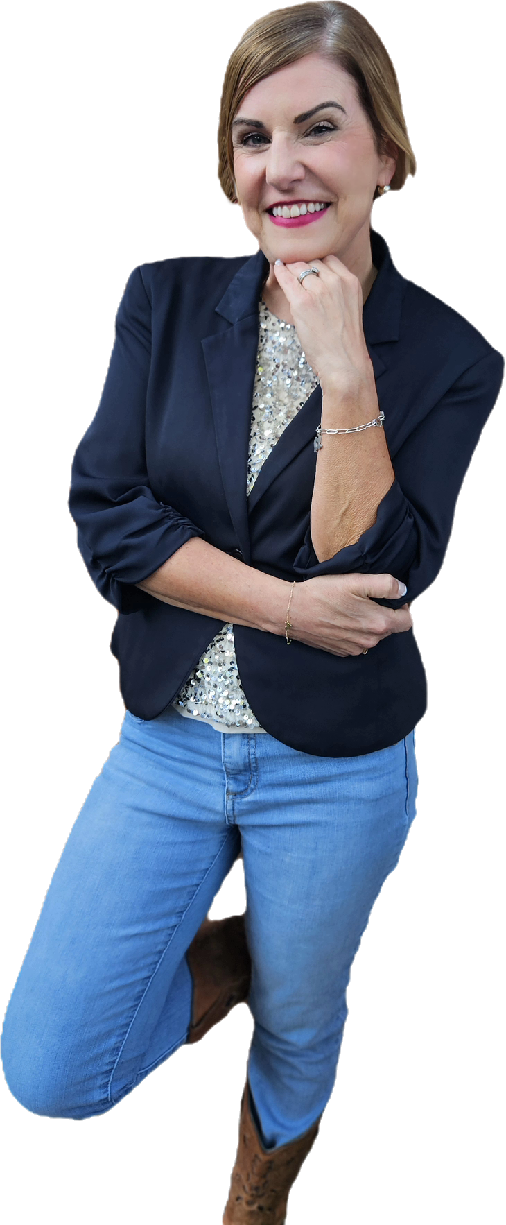 Rachel Muir, a vibrant nonprofit fundraising consultant, smiles confidently in a navy blazer over a sparkling shirt, showcasing her fun personality amid a bright, engaging background.