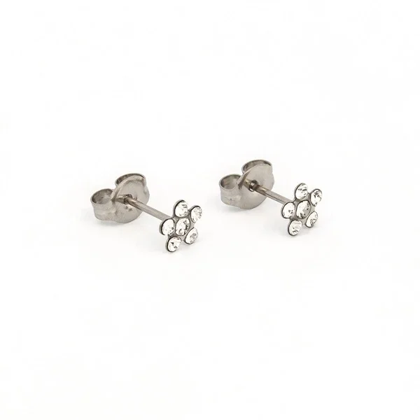 A pair of silver flower-shaped stud earrings with small clear stones.