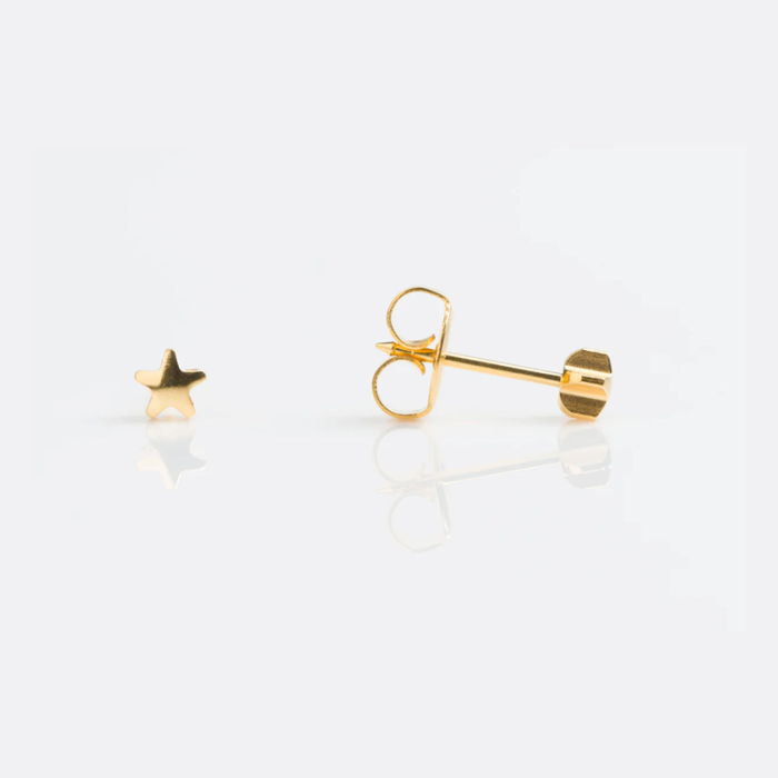 Gold star-shaped earring on a white background.
