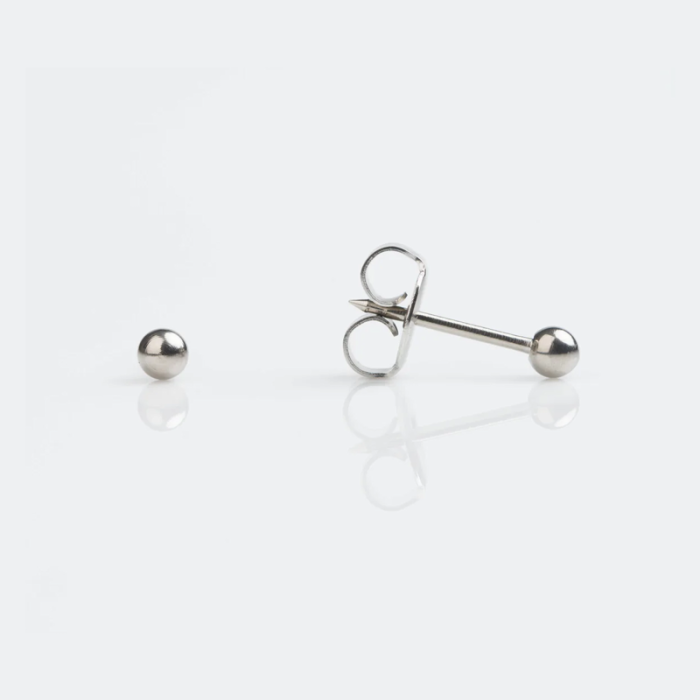 A pair of silver ball stud earrings, with one earring lying on its side and the other upright against a white background.