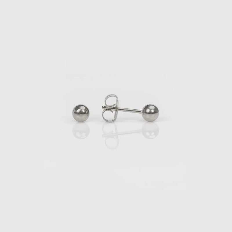 Silver stud earrings with spherical balls on a white background