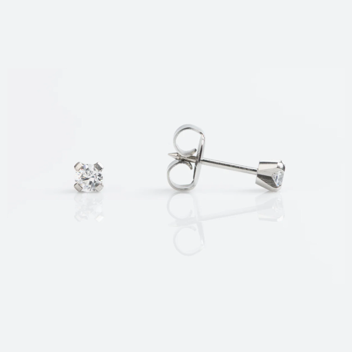 Close-up of a pair of diamond stud earrings on a white background.