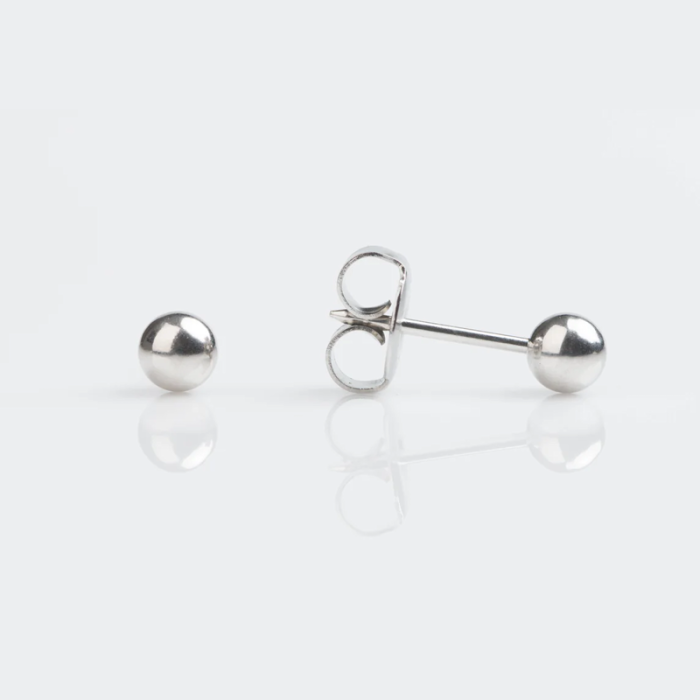 Silver sphere stud earrings, one lying flat and the other showing its post for piercing, on a white background.