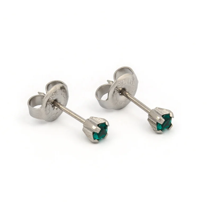 Silver stud earrings with green gemstones on white background.