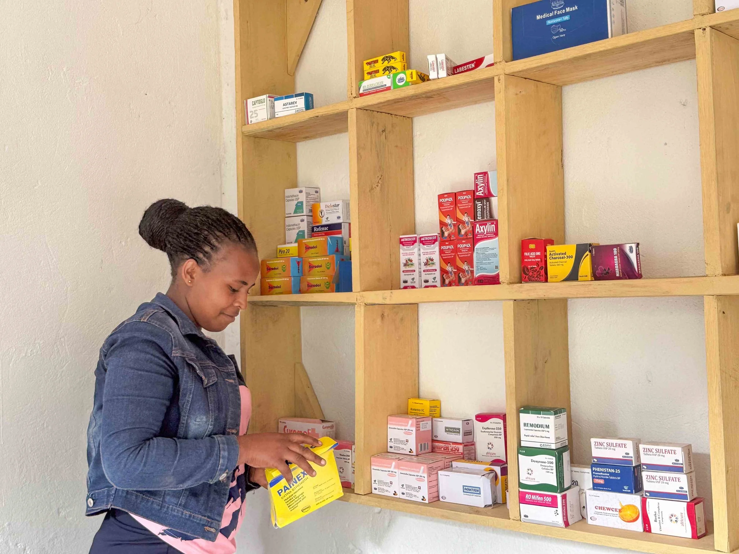 Nurse Judith stocking medicine in the H2H Medical clinic Uganda, Africa