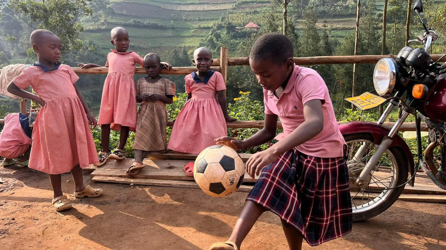 Little girls playing soccer in Uganda Africa