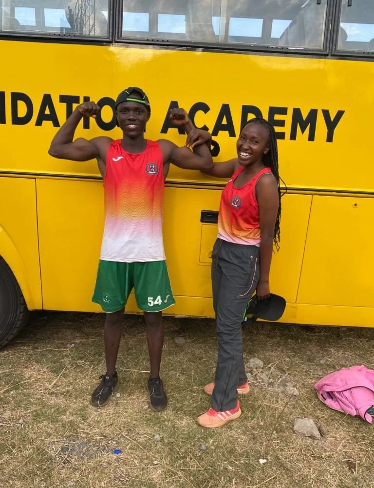 Julius showing  off his muscles in front of a bus at Strathmore University in Nairobi, Kenya
