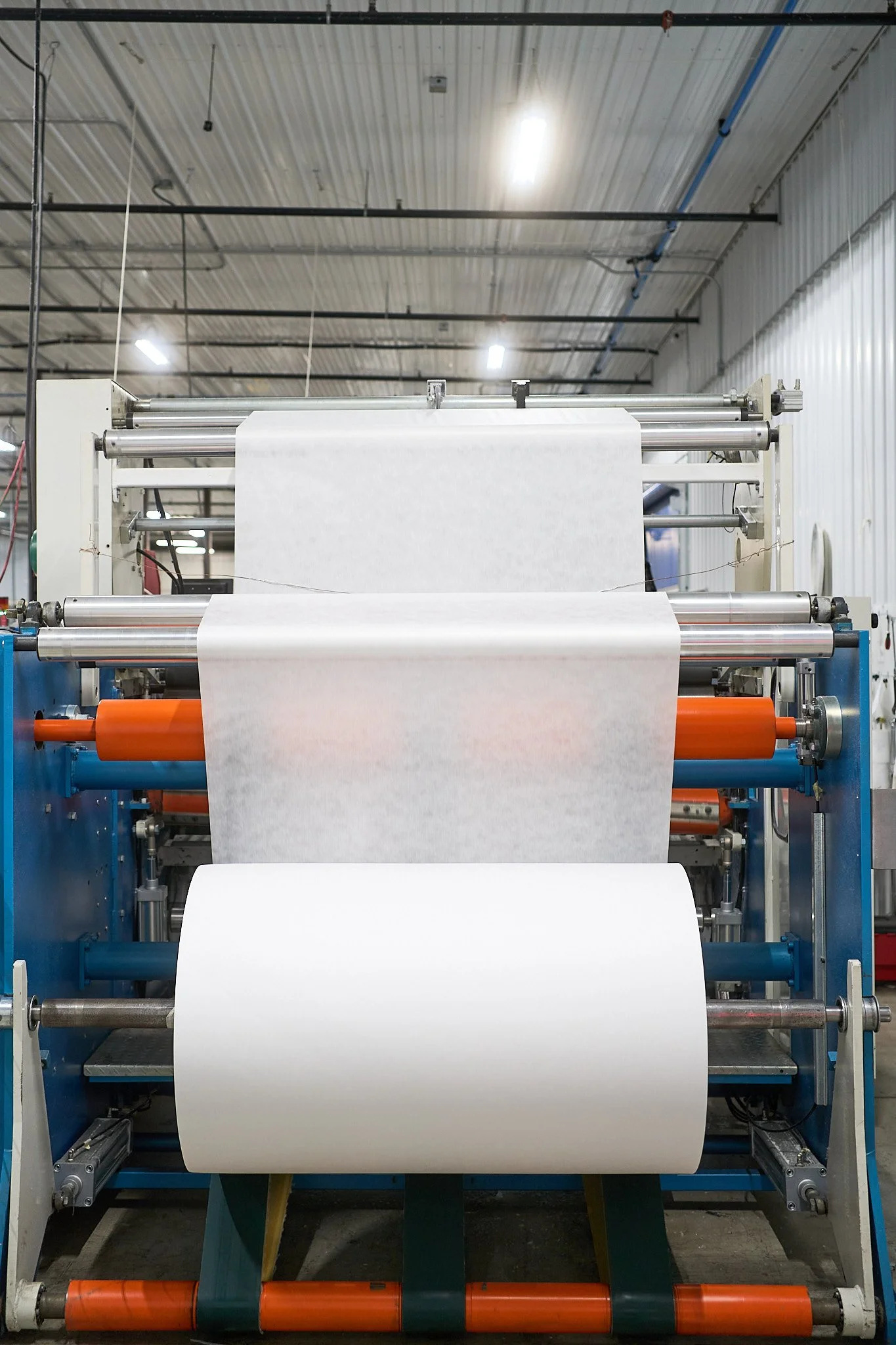 Wipe roll machine making canisters of wipes at Top Brass