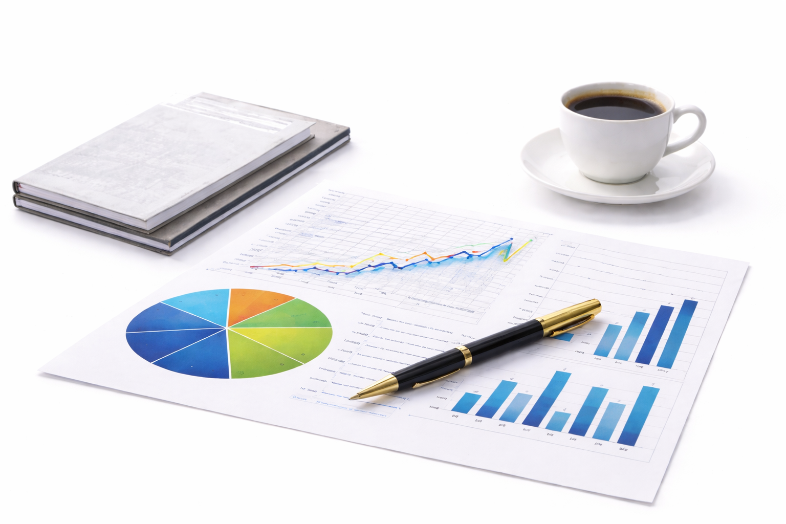 Business documents with charts and graphs, a pen, a cup of coffee, and notebooks on a white surface.