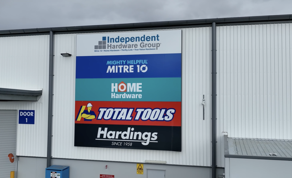 Large store sign advertising various hardware brands