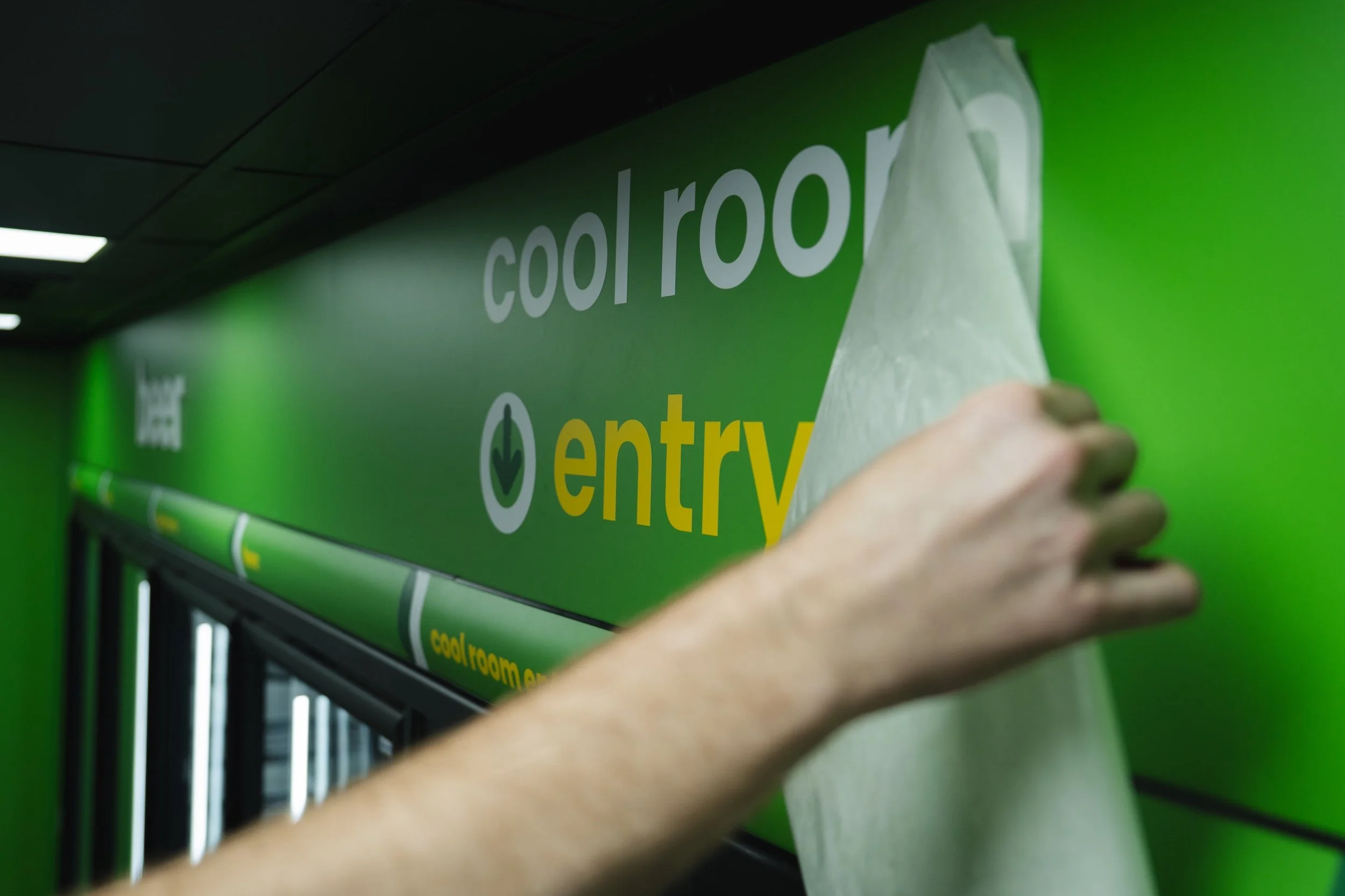 Bottle-O interior signage installation by Kaboom Projects team