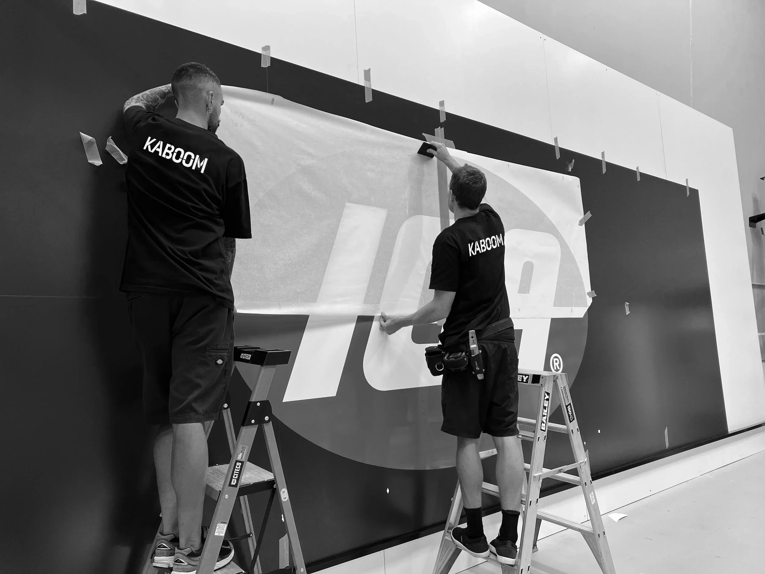 Commercial signage installation in progress by Kaboom Projects