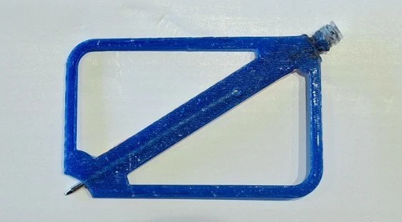 Blue plastic frame with a diagonal support bar and a small screw attached to the top right corner.