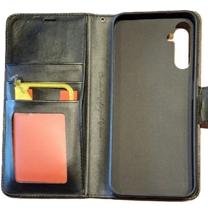 Open black leather phone case with a yellow and orange toy car and a red portable charger inside.