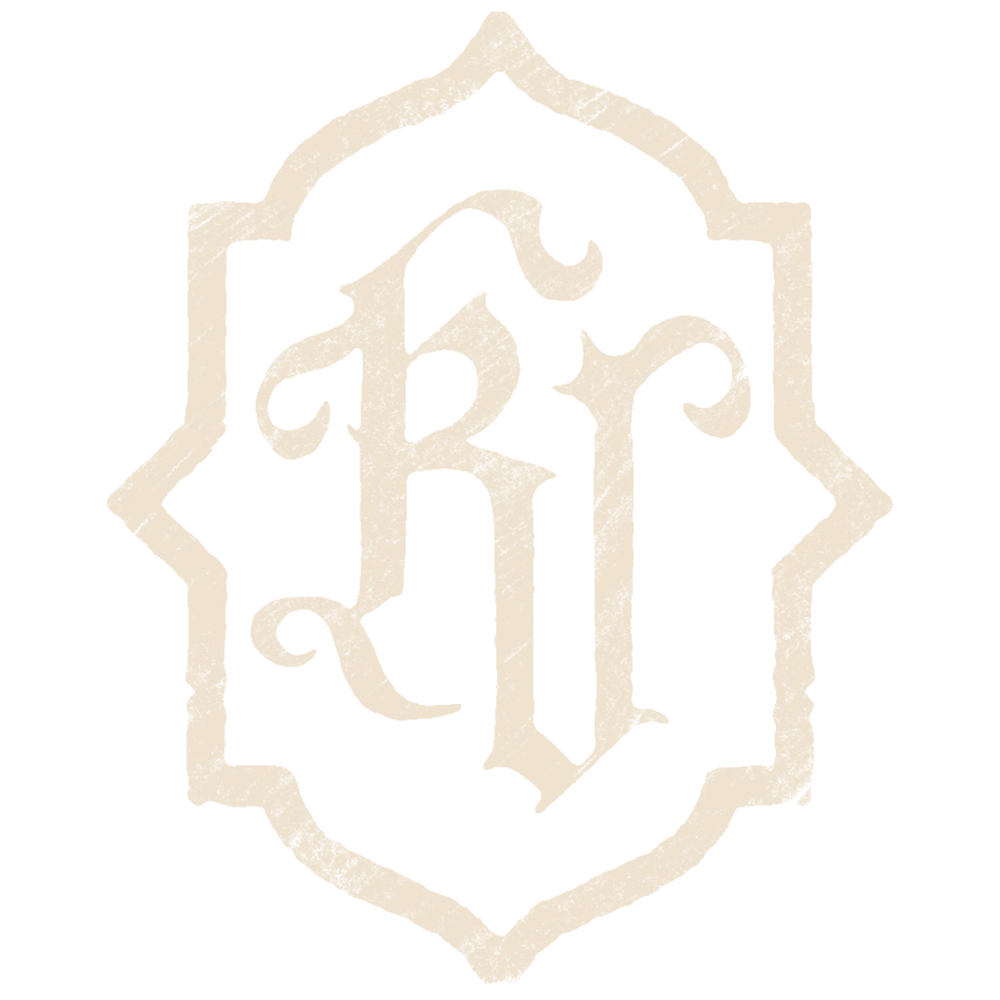A stylized logo with the letters 'KV' inside an ornate shield-like border.