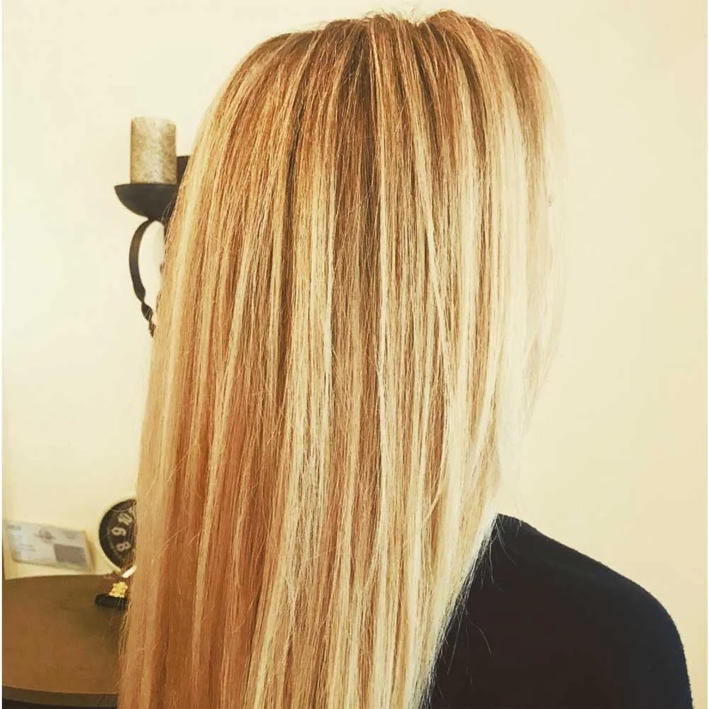 Back view of a woman with long, straight, blonde hair.