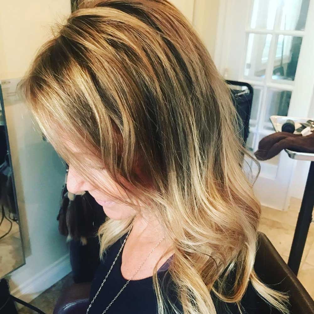 From bleach blonde to this beautiful caramel brown... (smudge the roots into the highlights and lowlights, then tone the blonde)