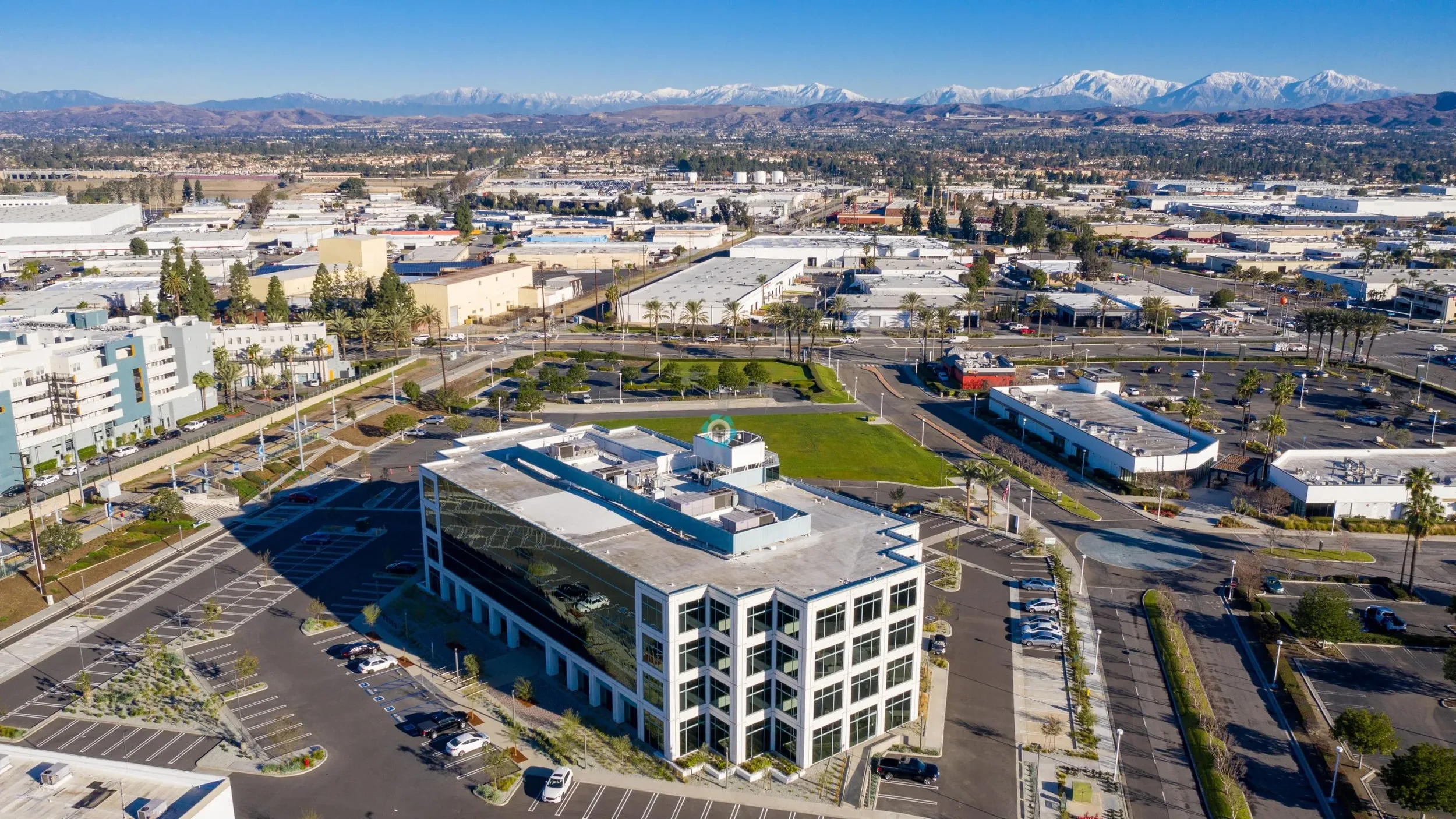 Commercial property aerial drone image showing office building and surrounding development
