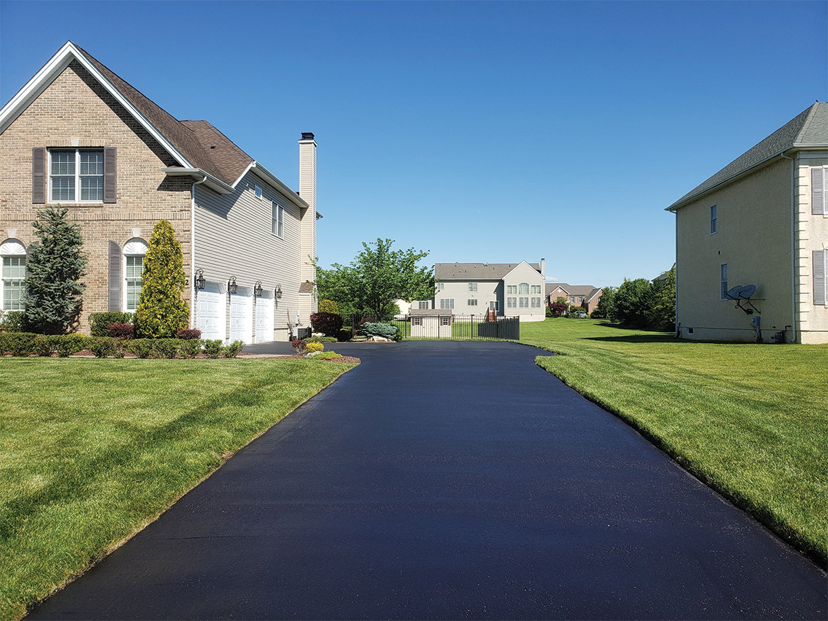 Freshly paved black asphalt driveway in a suburban neighborhood in ashburn virginia