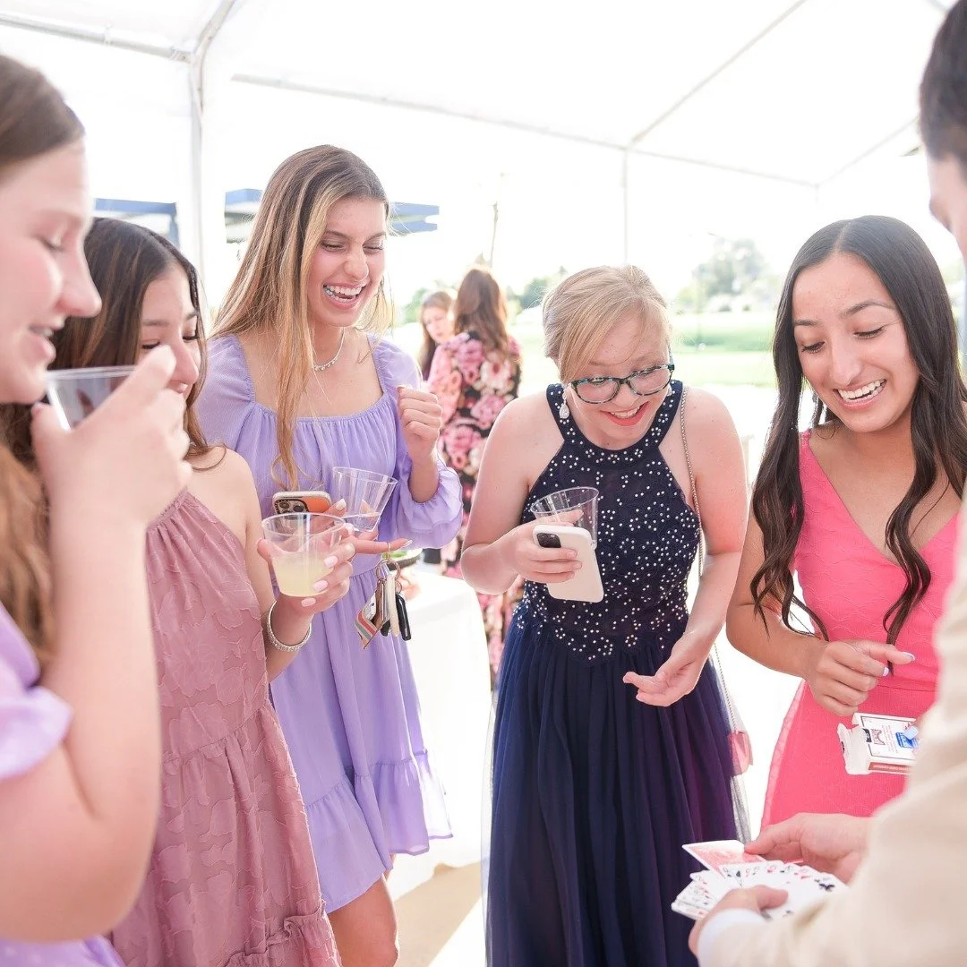 Brady showing magic trick to group of high school girls.