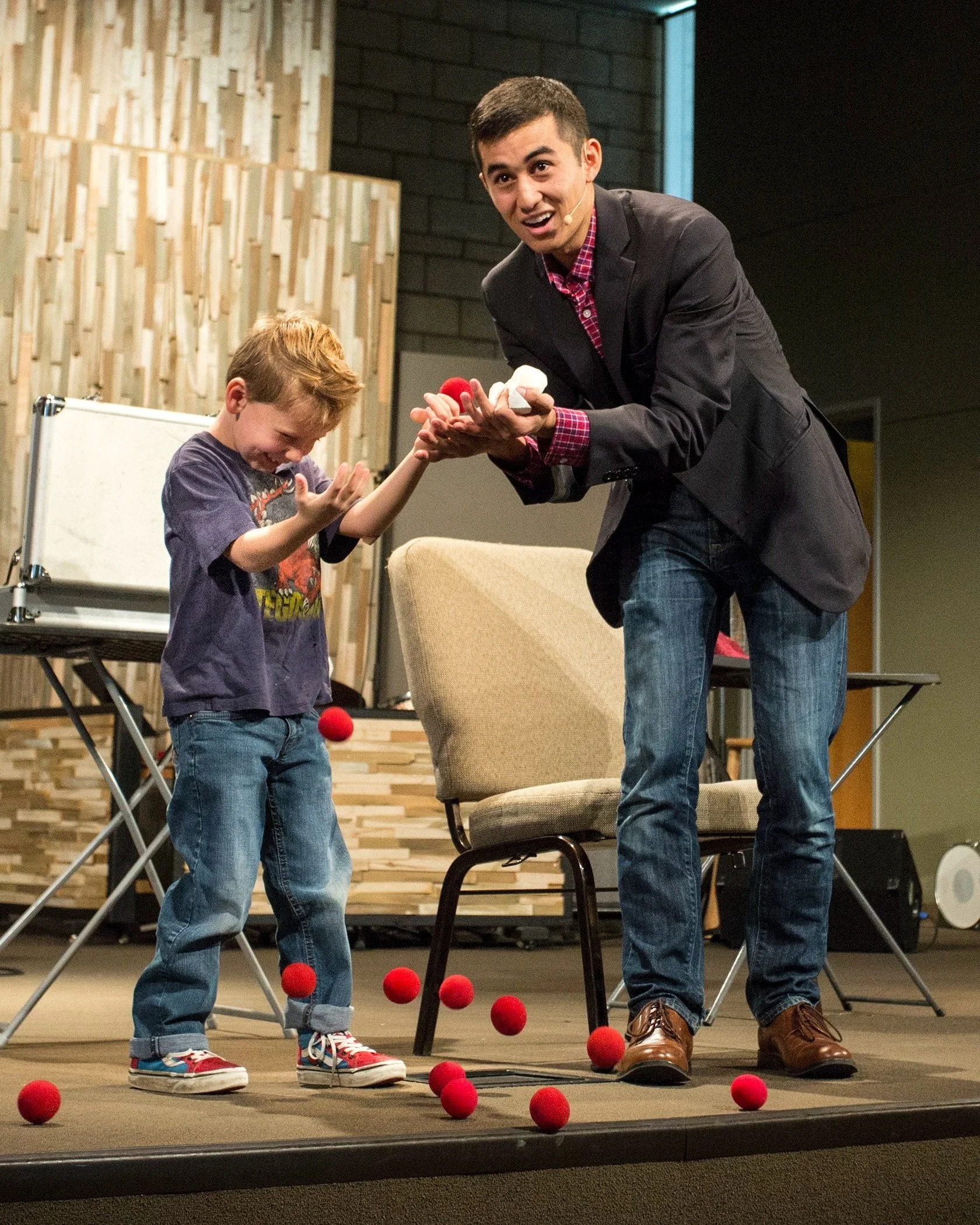 Boy experiencing surprise and delight as he enjoys Brady's magic trick.