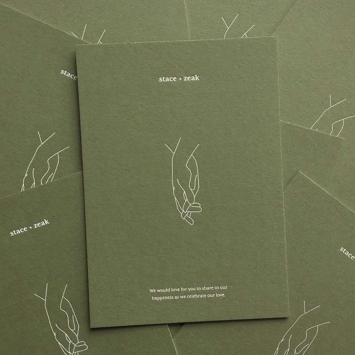 Green wedding invitation card with minimalist line art of two hands holding, and the text 'stace + zeak' at the top and a message inviting sharing in happiness at the bottom.