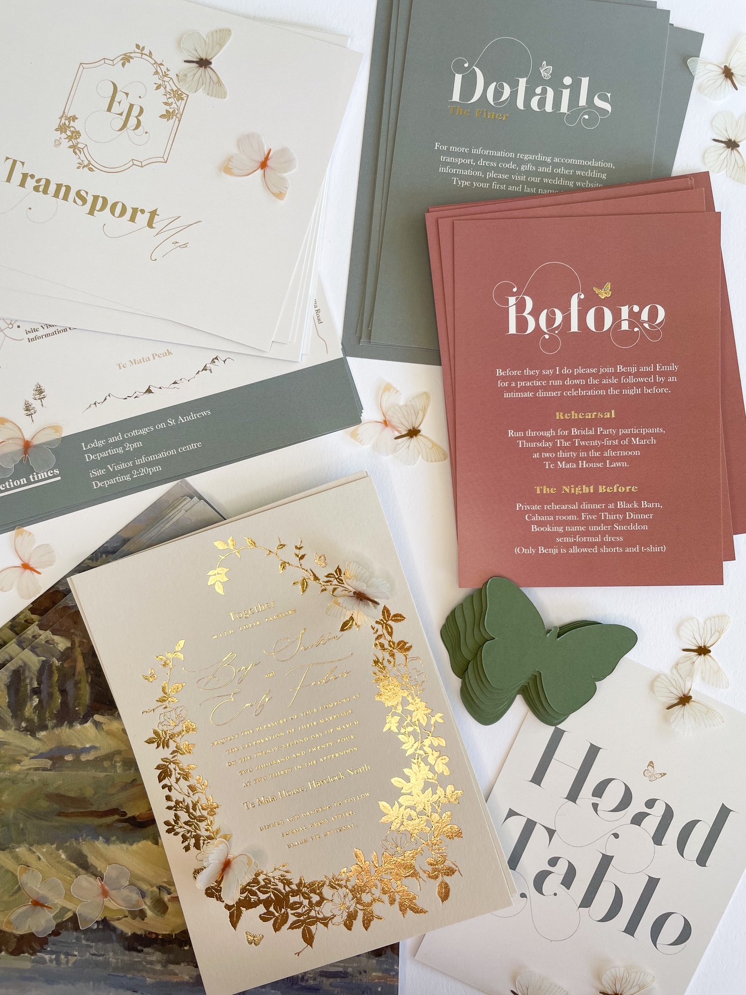 Wedding invitation suite featuring elegant fonts and gold foil details, with floral and butterfly embellishments, including transport map and rehearsal dinner information.