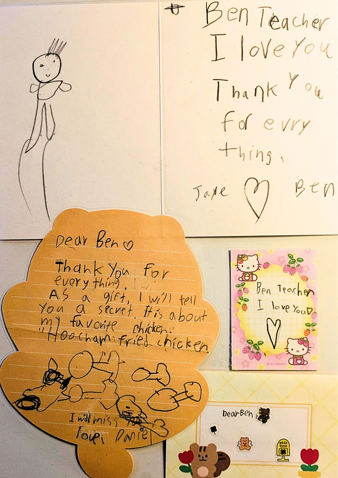 A collection of handwritten notes and drawings from children, including a thank you note to a teacher, a drawing of a person, and a colorful Hello Kitty card.
