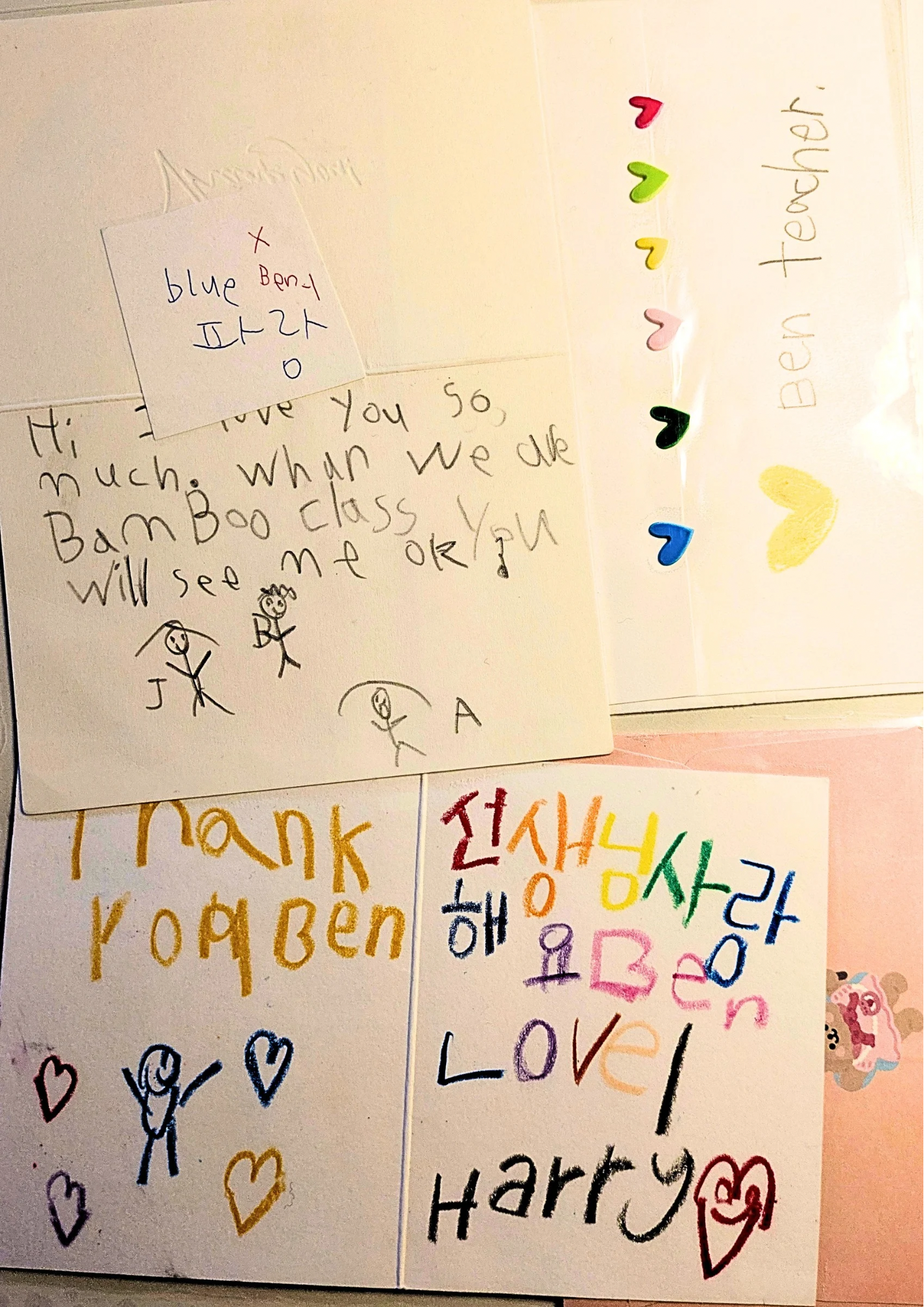 Colorful handmade cards with handwritten messages of love and gratitude, featuring hearts, smiley faces, and drawings.