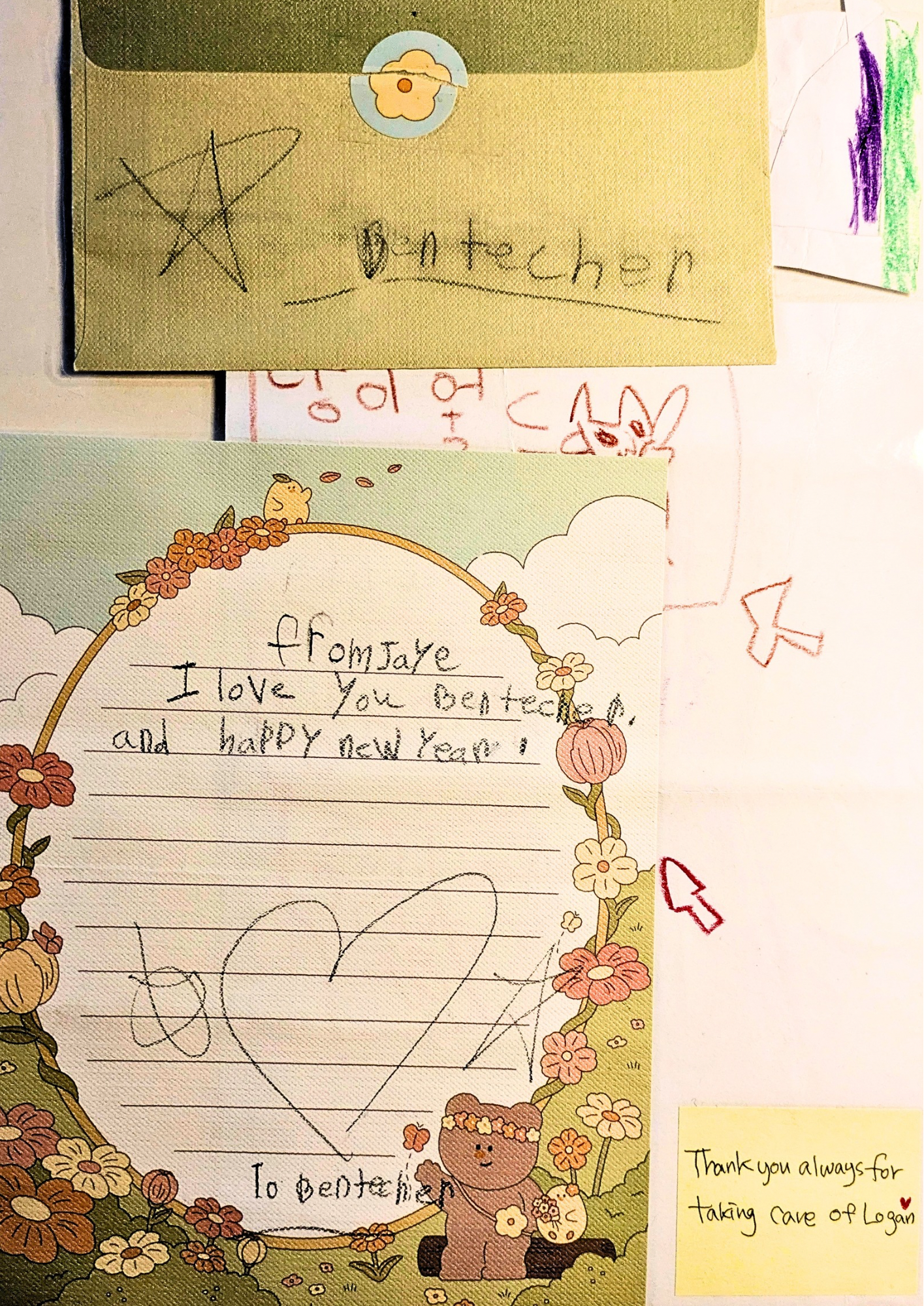 Various handwritten notes and drawings on colorful cards, including a star, a heart, and a teddy bear, with floral and nature-themed borders.