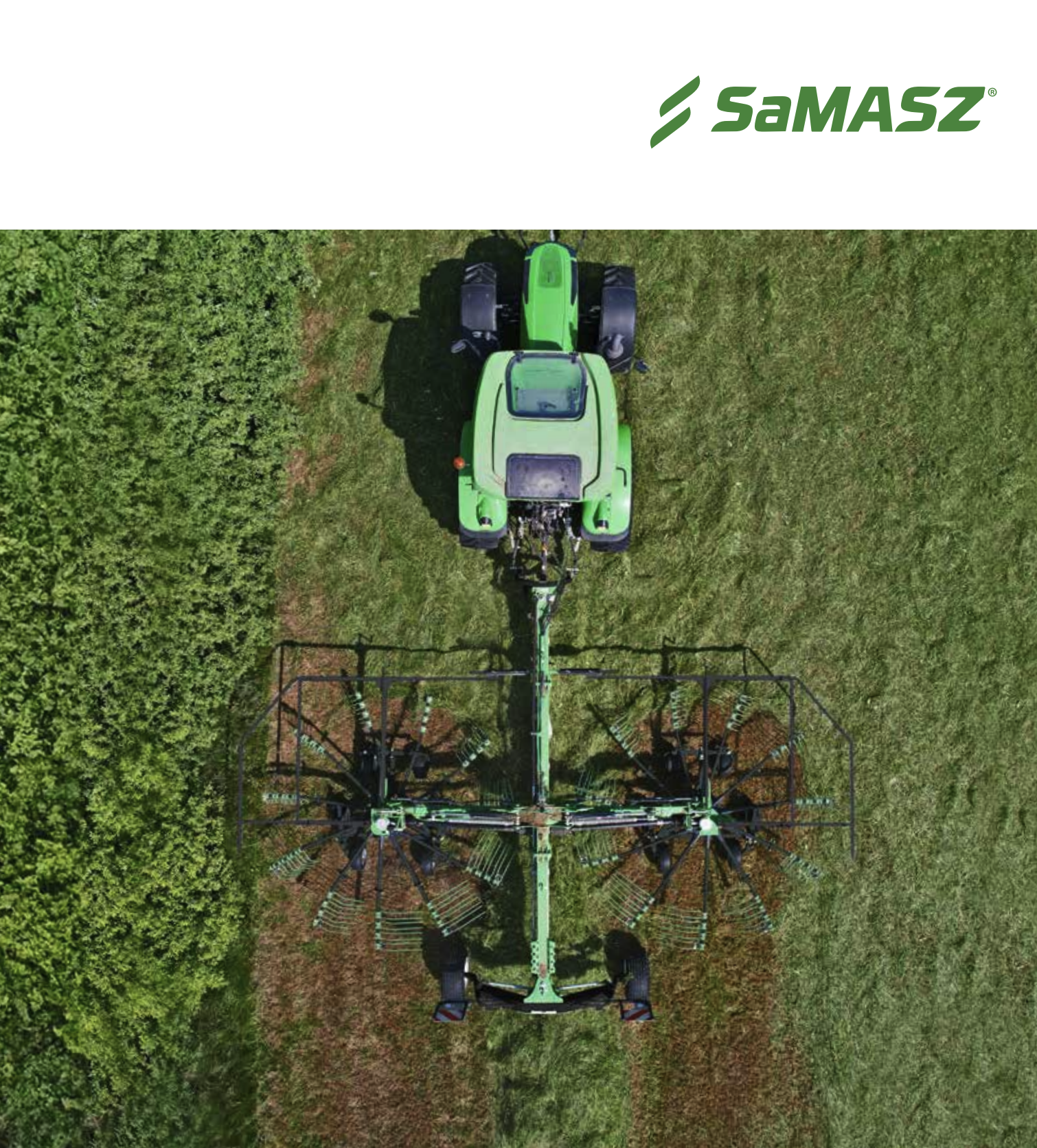 Top-down view of a large, green agricultural sprayer machine operating on a field, with lush green trees on the left side.