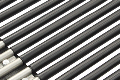Close-up of multiple black metal flashlight bodies lined up in a row.