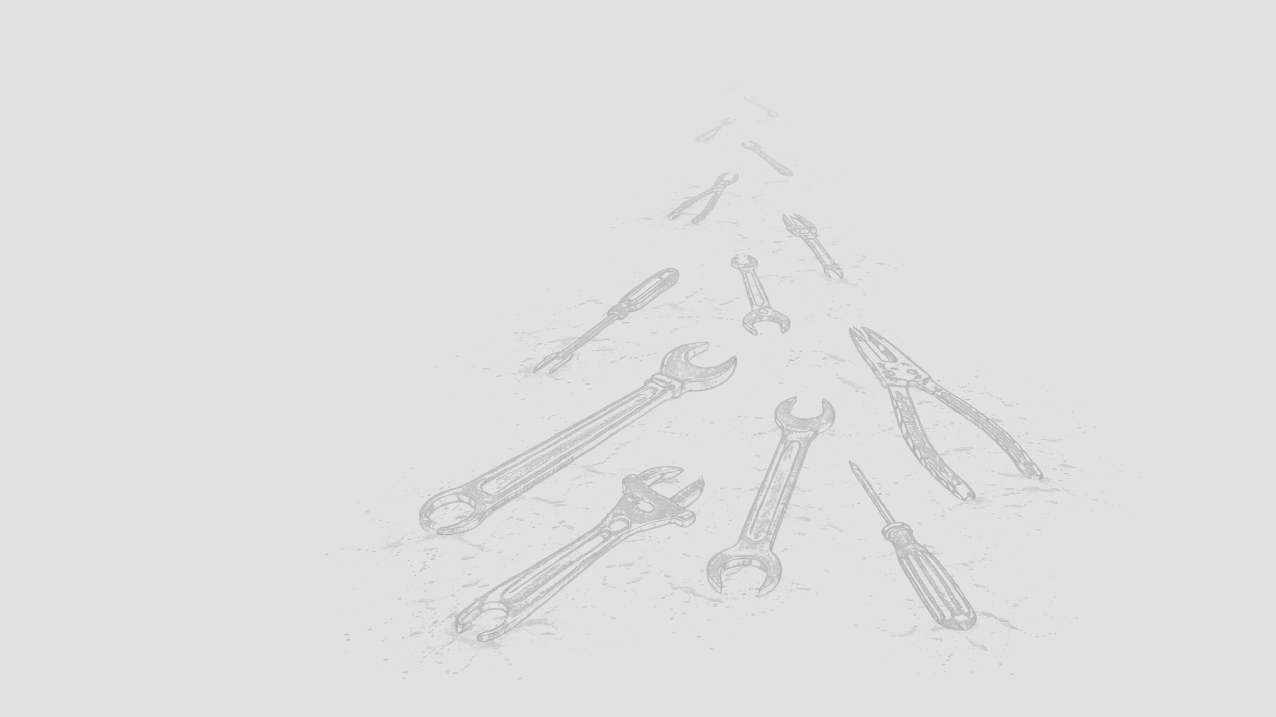 Various hand tools including wrenches, pliers, screwdrivers, a file, and a screwdriver, are arranged on a surface.