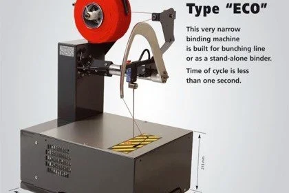 Close-up of a narrow binding machine labeled 'Type ECO' used for bunching lines or standalone binding, with a red wheel and metallic arm, set on a gray table.