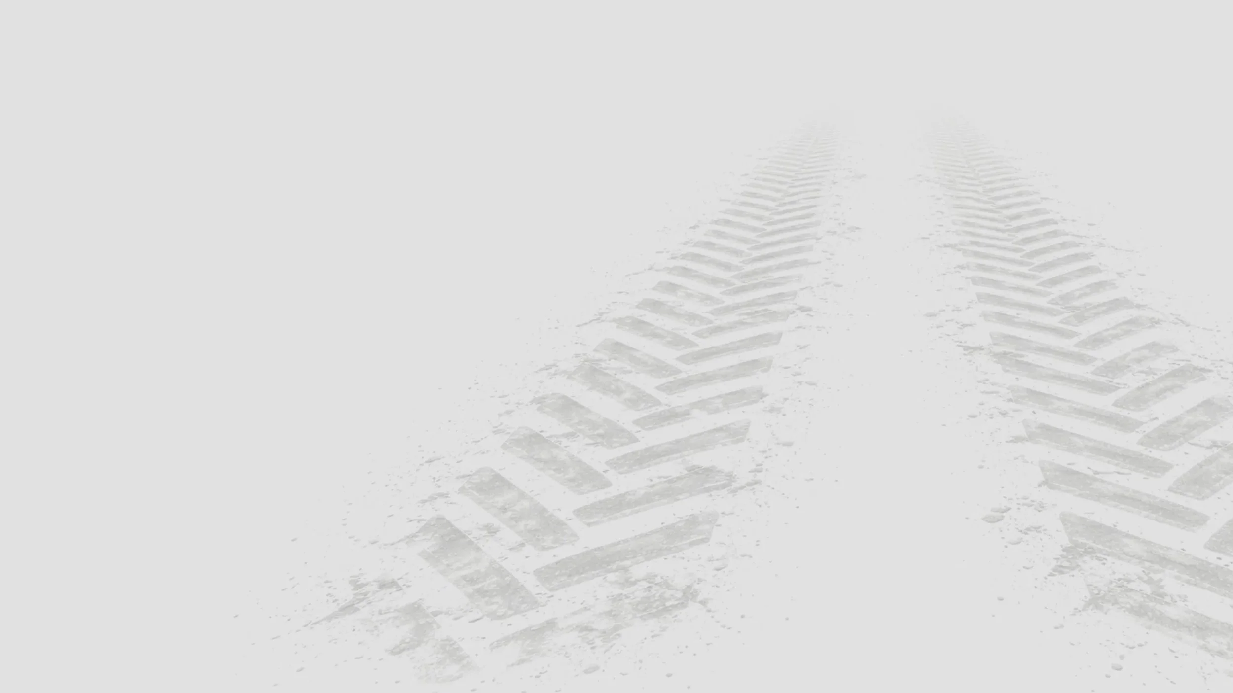 Tire tracks on snow-covered ground with tire marks fading into the distance