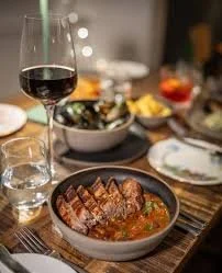 THE DUNVEGAN HOTEL  -  By day, a cosy spot for coffee, cakes and a relaxed Scottish lunch. By evening, it transforms into the Fire Restaurant — a multi-course dining experience built around local, seasonal ingredients, all cooked over fire.