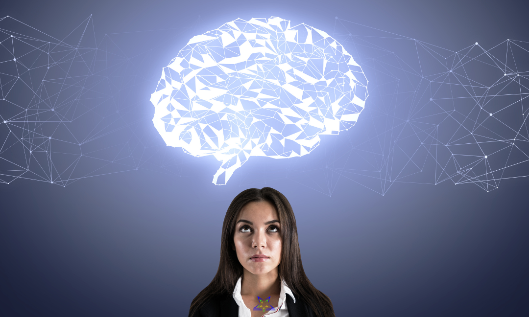 A woman with long, brown hair and wearing a white shirt and black suit jacket is standing against a blue background. She is looking up at an illuminated image of a brain projected above her head