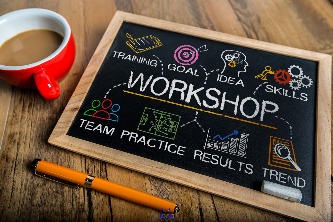 Image shows a red coffee cup and chalkboard on a table. The writing on the chalkboard says Workshop and around it Training, Goal, Idea, Skills, Team, Practice, Results, Trend