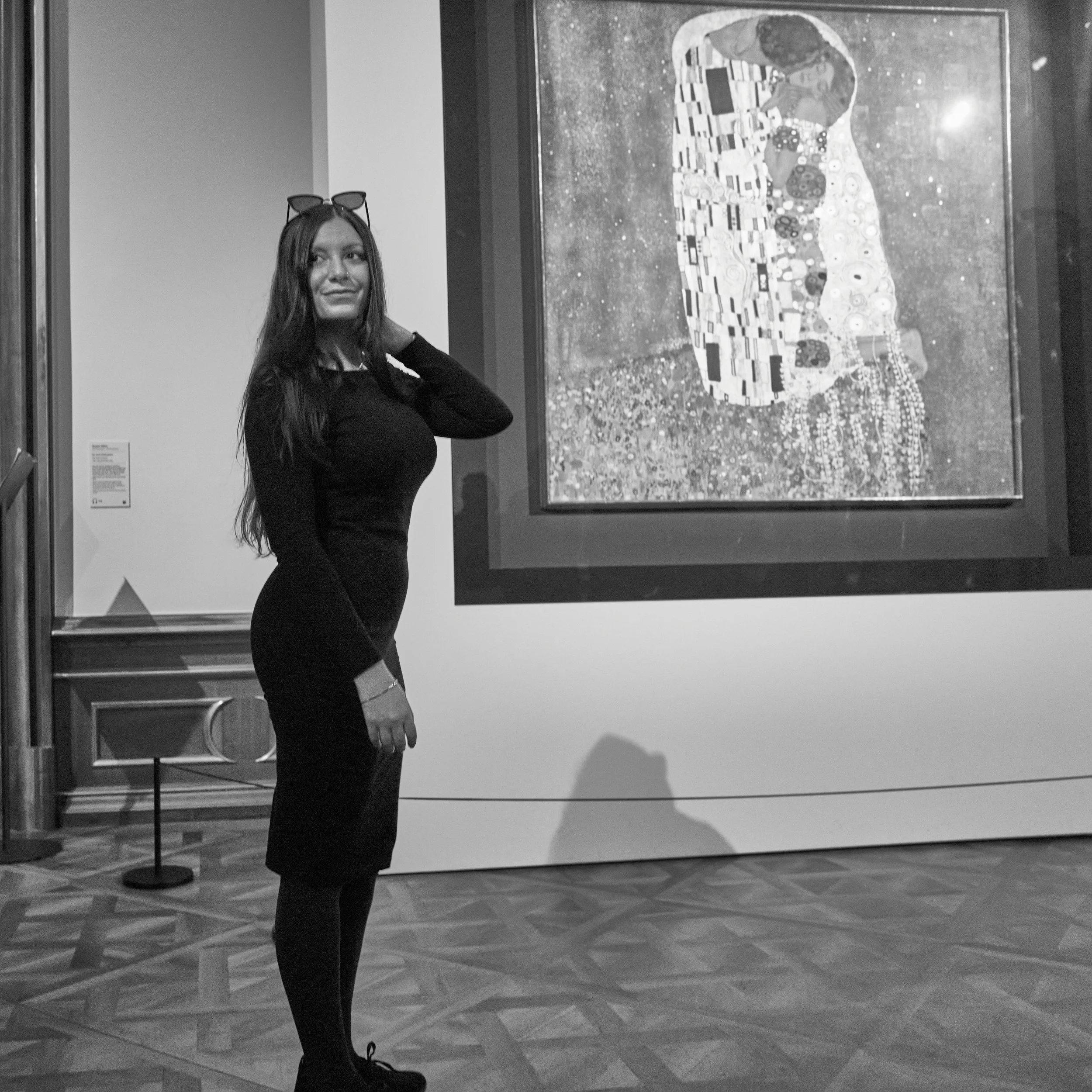 A young lady posing infront of The Kiss