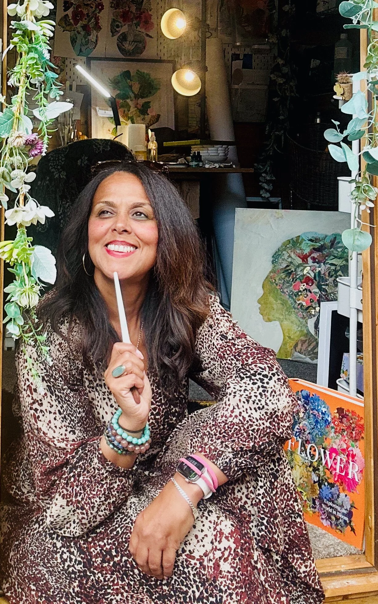 Mixxed-media artist Danielle Jackson seated on her studio step, based in Horsham, West Sussex.