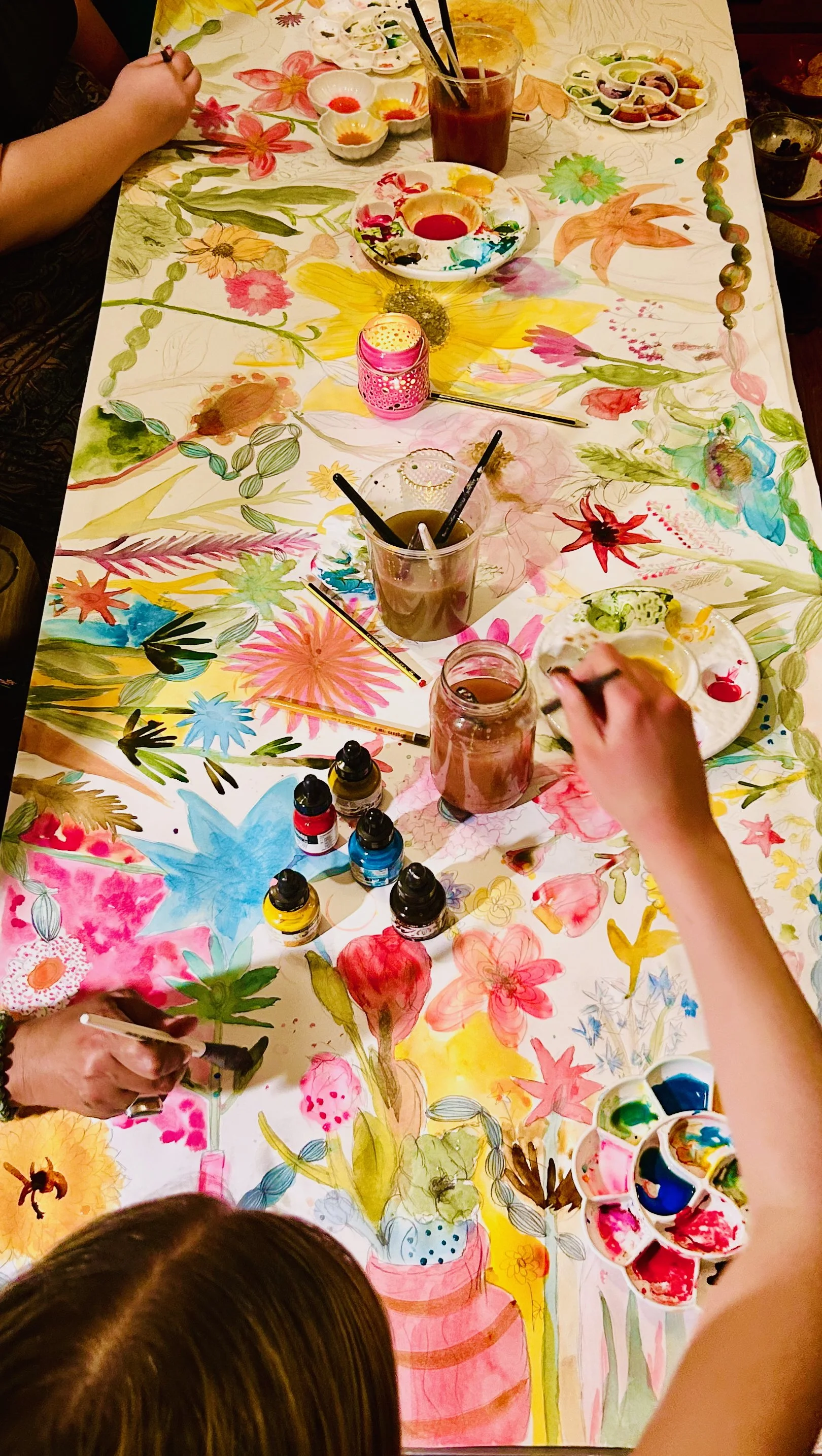 Close-up of participants adding vibrant colour to their pencil drawings during Pause & Bloom workshop.