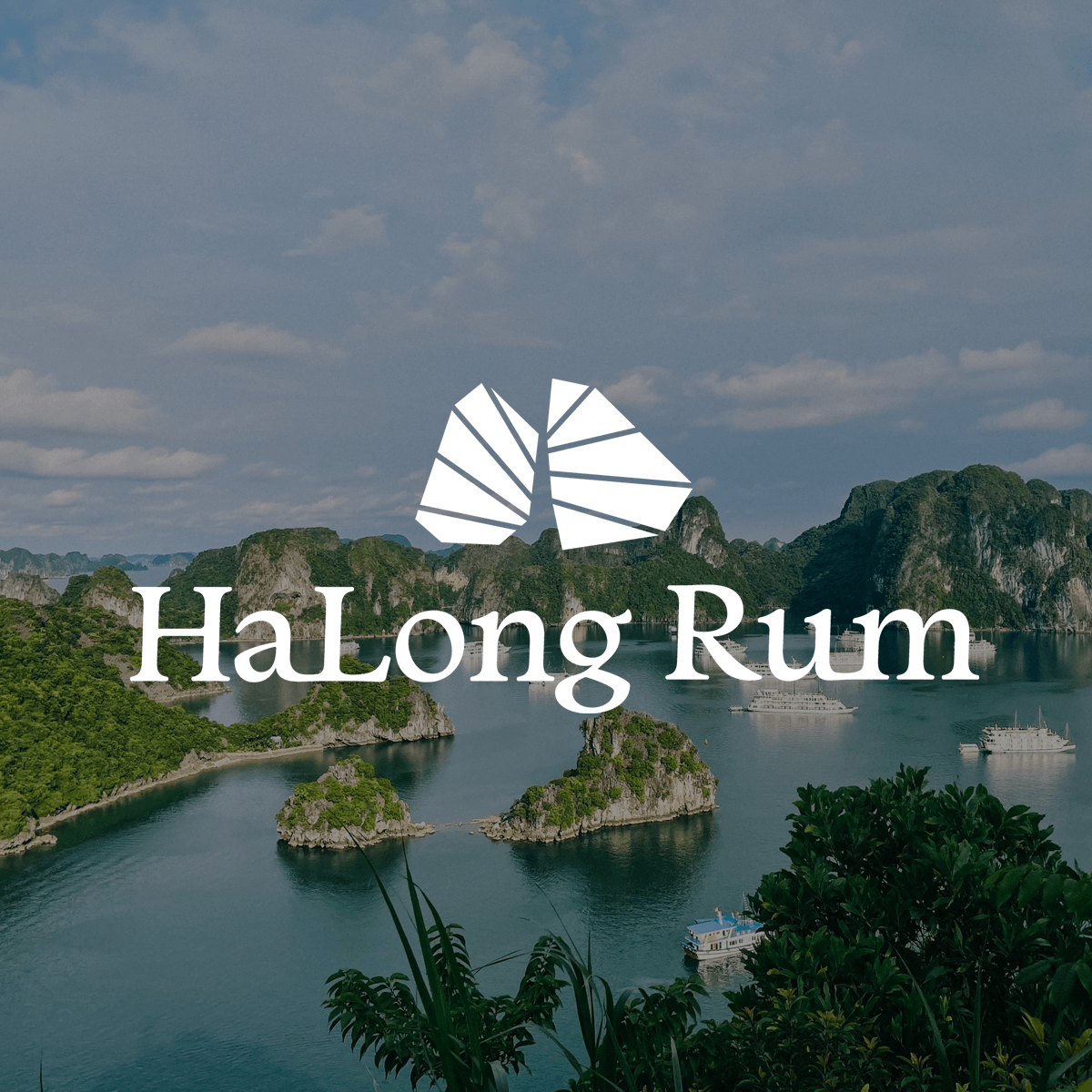 Scenic view of limestone islands and boats in Halong Bay with the Halong Rum logo overlay