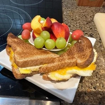 Egg and cheese on toast with fruit