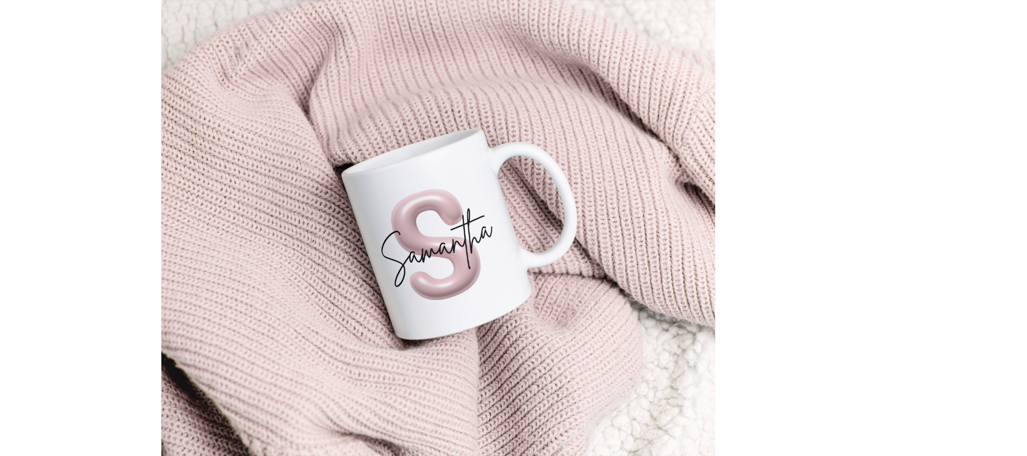 Personalized white mug with the letter 'S' and the name 'Samantha' on a pink knitted blanket.