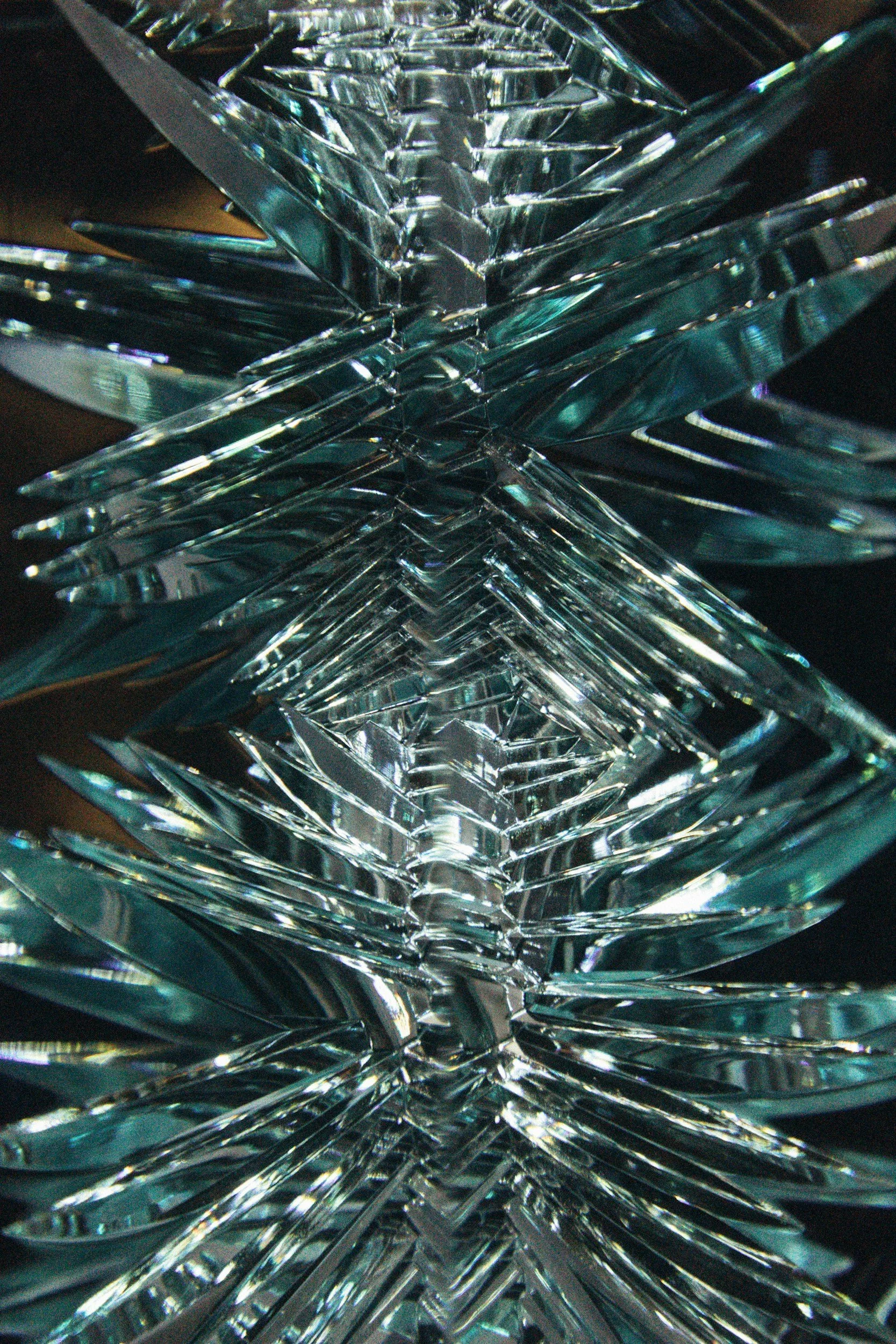 Close-up of shattered glass pieces layered in a geometric pattern.
